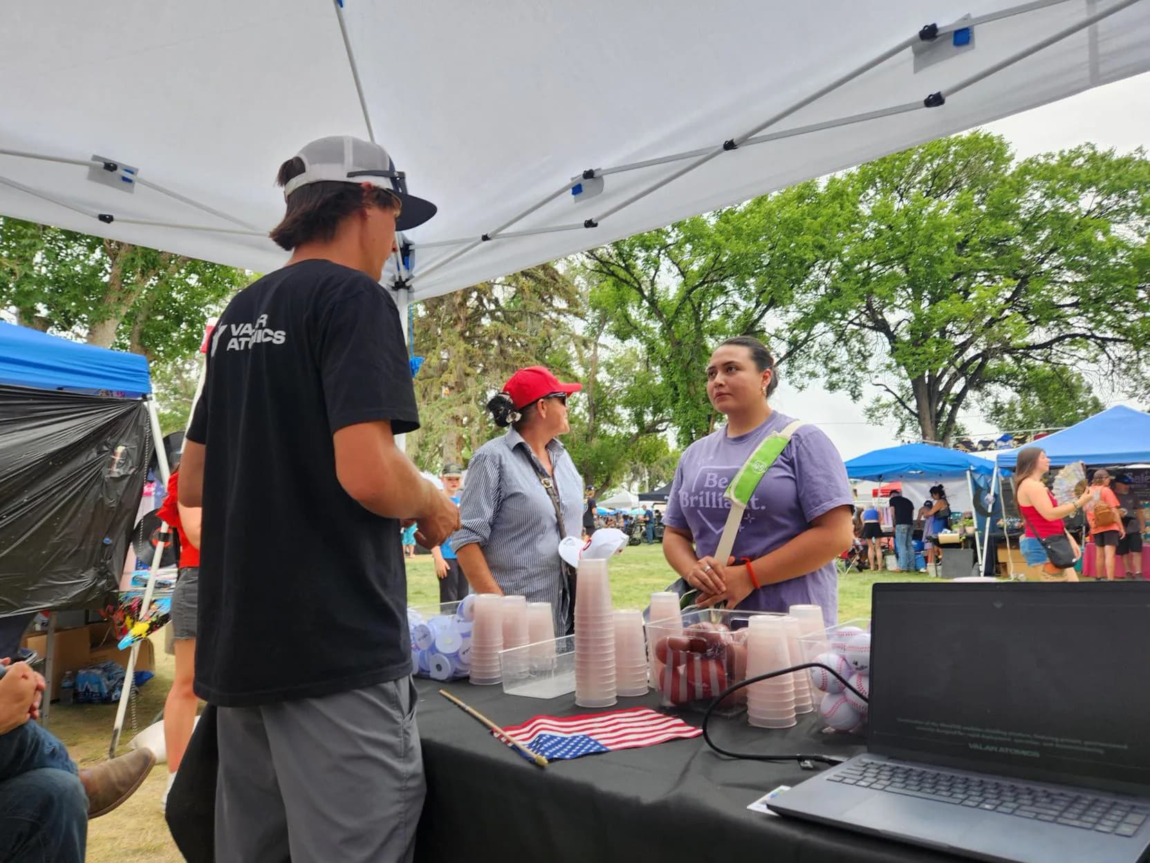 Valar Atomics team at a community event table